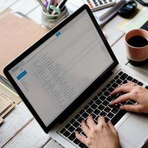 Businesswoman Checking E-mail Online on Laptop